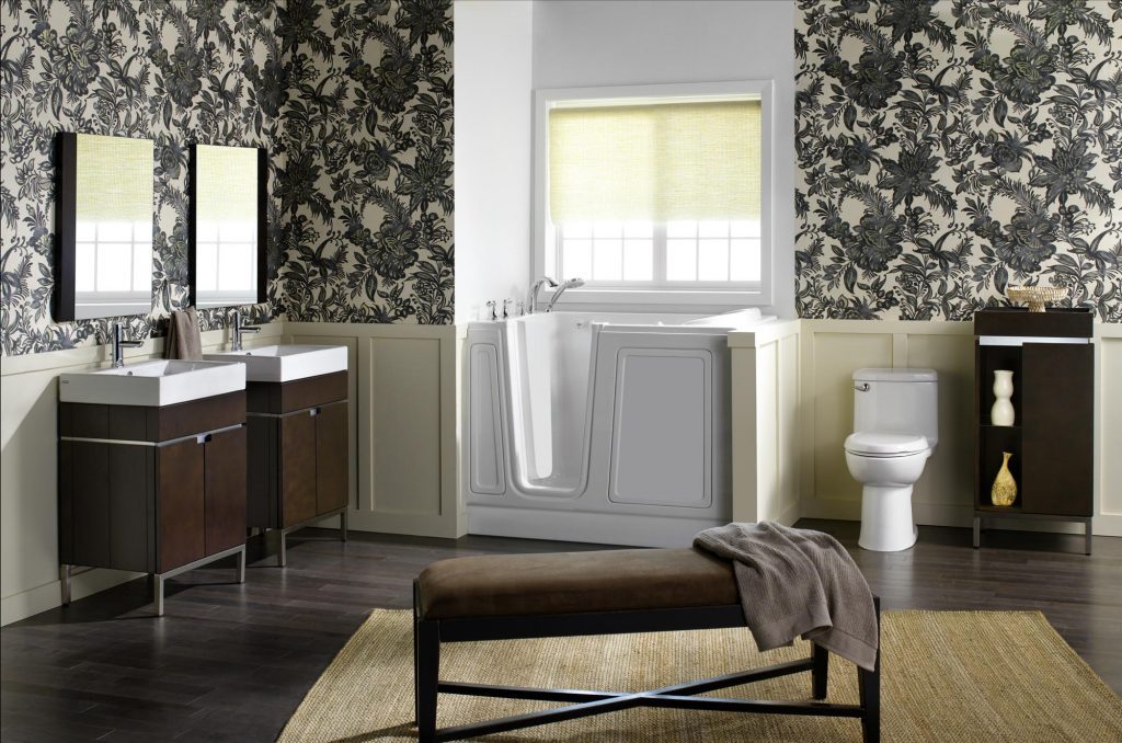 Bathroom with patterned wallpaper and white bathtub.