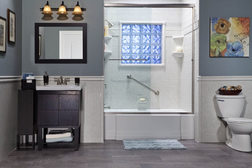 A modern bathroom with blue walls and white fixtures.