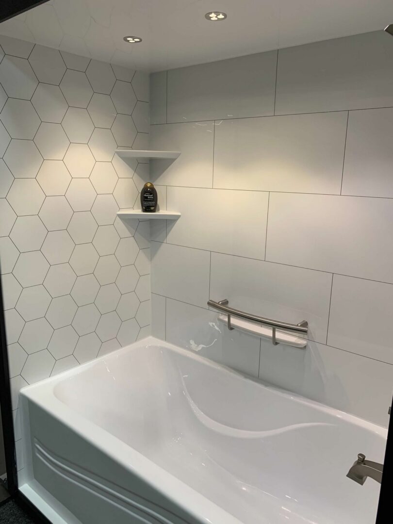 White bathtub in tiled bathroom.