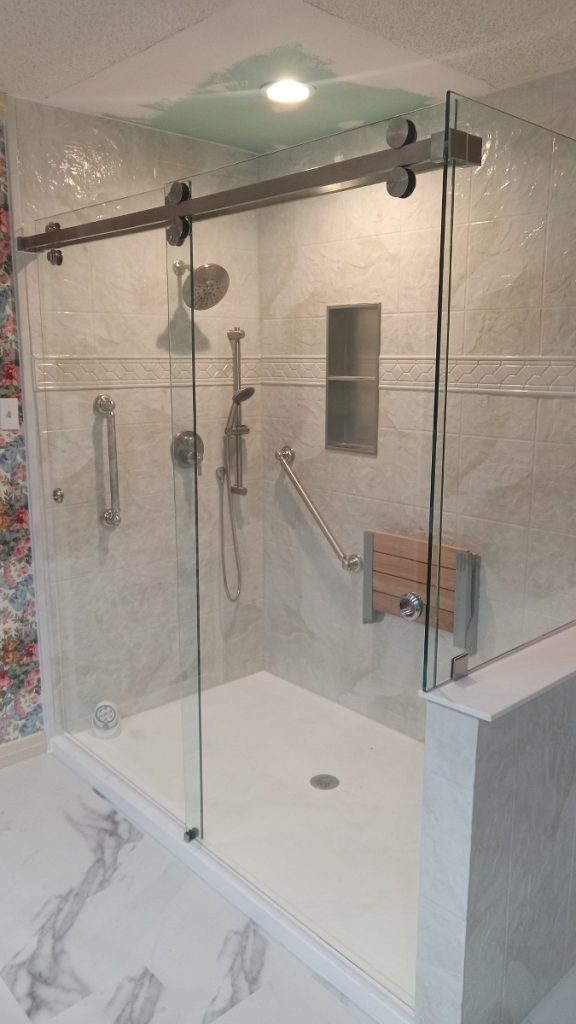 A modern bathroom with a glass door shower.