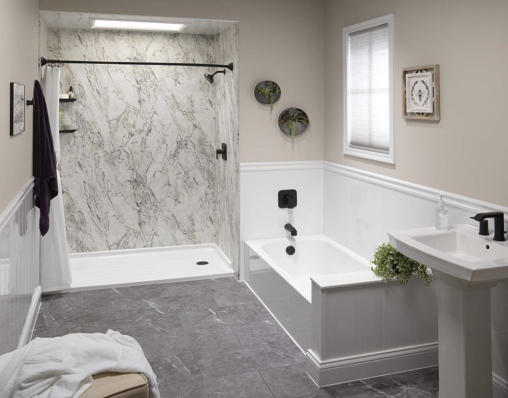 A modern bathroom with marble-look wall panels and a bathtub.
