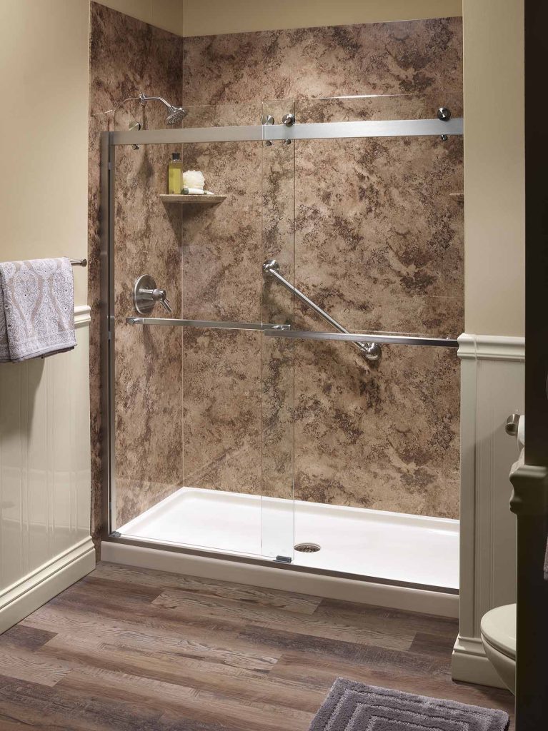 A modern shower with brown marble walls and a glass door in Texas by Affordable 1 Day Baths