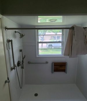 Accessible shower with window and grab bars.