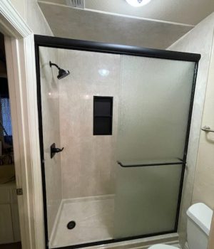 Modern bathroom with glass shower door.