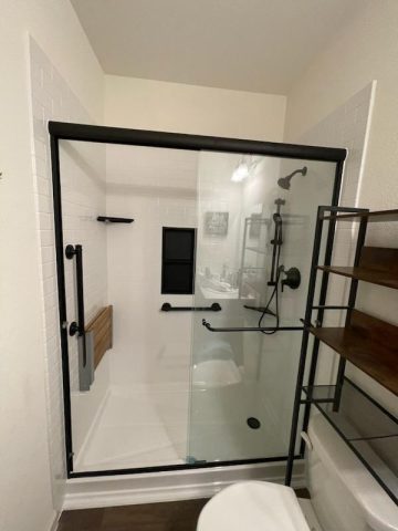 Modern bathroom with large glass shower enclosure.