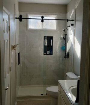 Modern bathroom with glass shower enclosure.